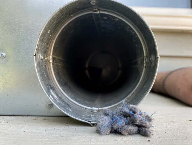 Barrington Dryer Vent Cleaning technician using specialized equipment to clear severe dryer vent blockage in Barrington